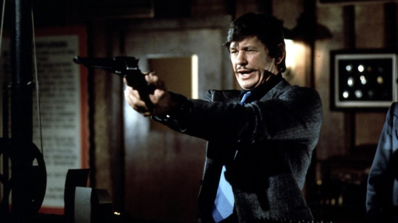 Charles Bronson aims gun