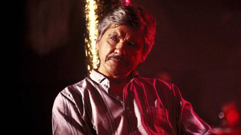 Charles Bronson sits in red light