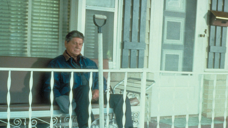 Charles Bronson sits on porch