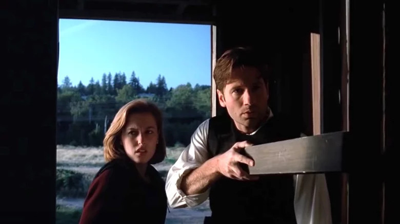 David Duchovny and Gillian Anderson as Mulder and Scully looking worried