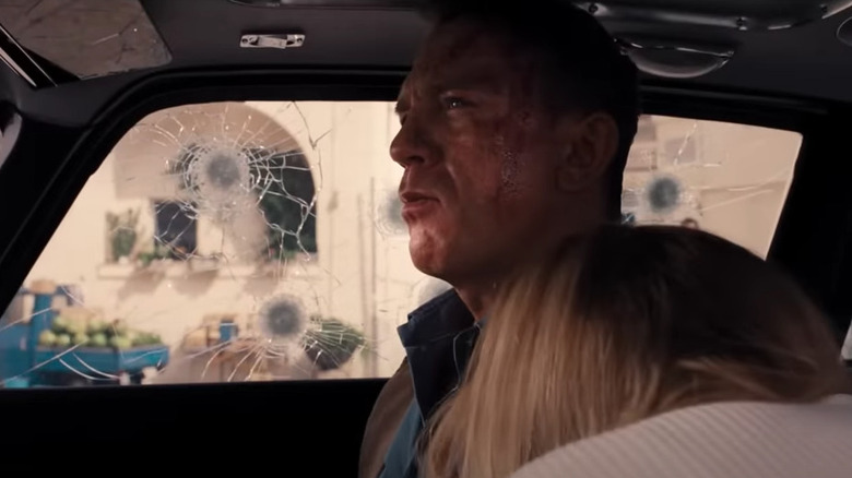 Bond looks through bullet-riddled car windows