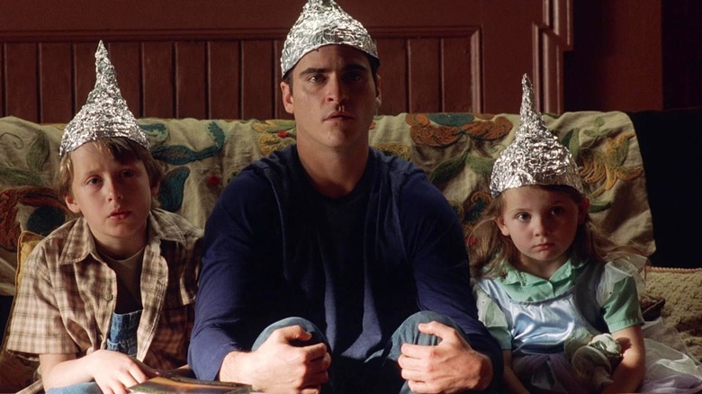 The Hess family sits with tinfoil hats