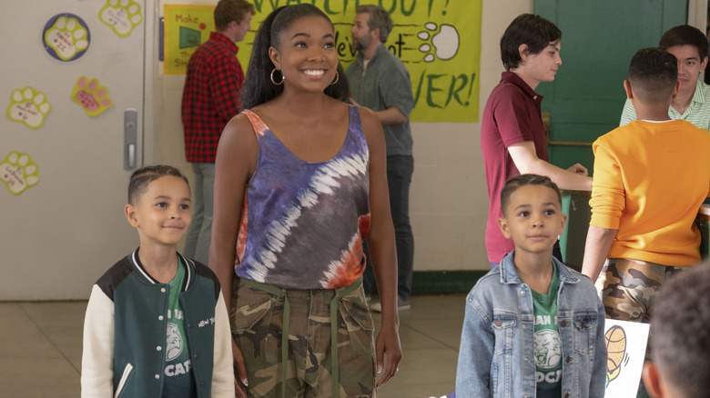 Zoey Baker standing with two kids