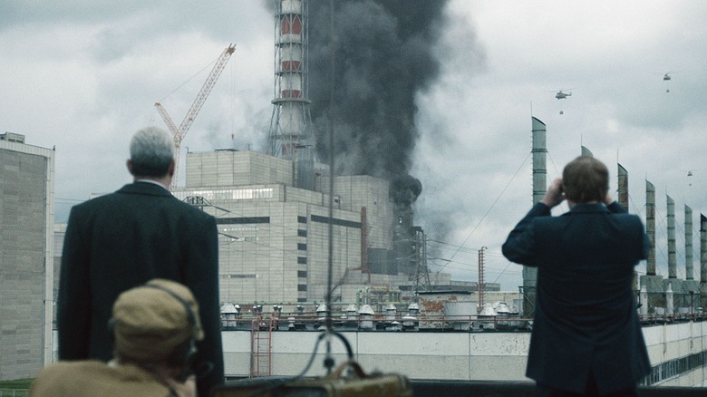 Two men look at the Chernobyl reactor smoke