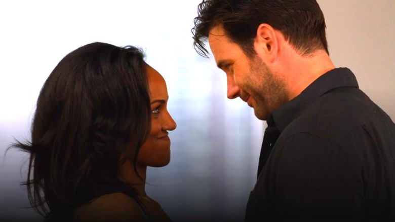 Mekia Cox and Colin Donnell smiling at each other