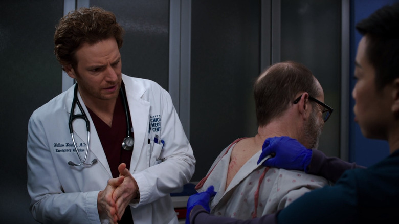 Dr. Will Halstead looking at Walter's back worriedly