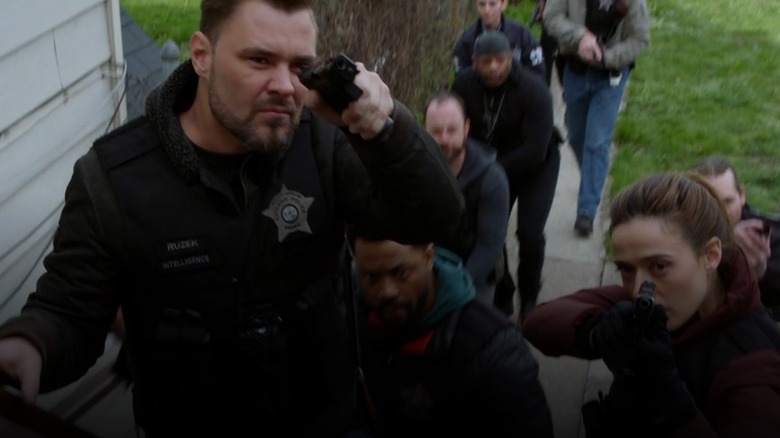 Patrick John Flueger, LaRoyce Hawkins, Marina Squerciati with guns drawn