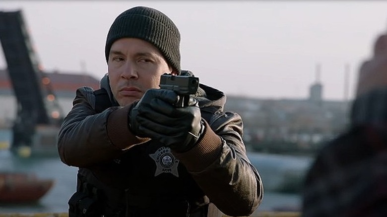 Antonio Dawson pointing gun 