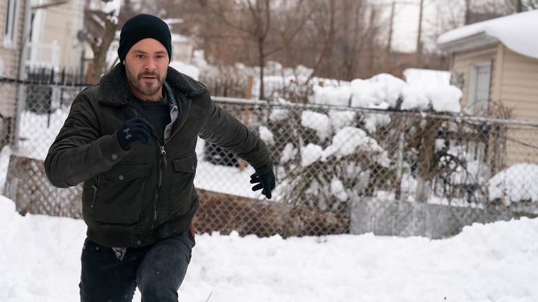 Adam Ruzek running through snow