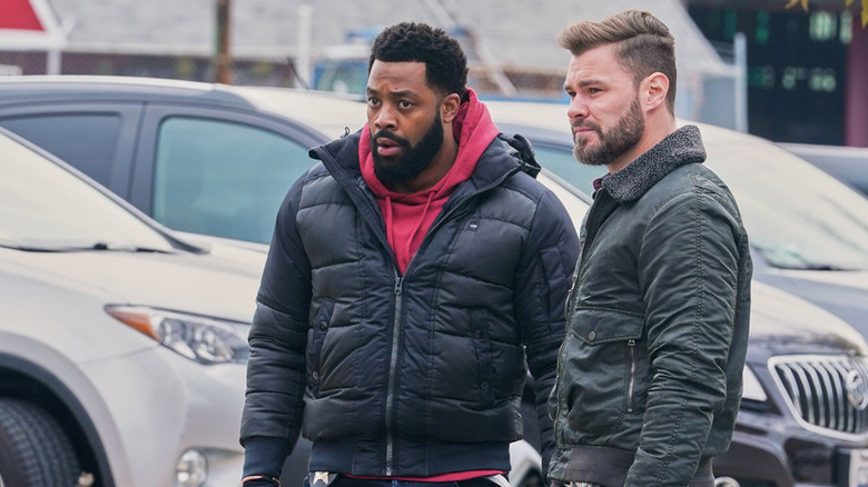 LaRoyce Hawkins and Patrick John Flueger standing together