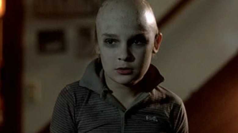 Corey Feldman as Tommmy Jarvis, shaved bald and staring intently