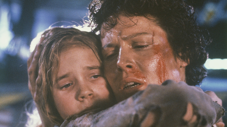 Ripley embraces newt in Aliens (1986)