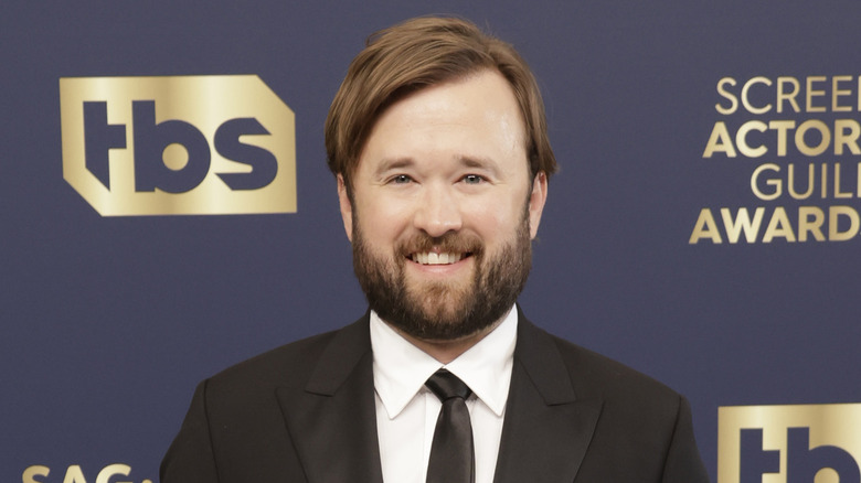 Haley Joel Osment smiling in suit 