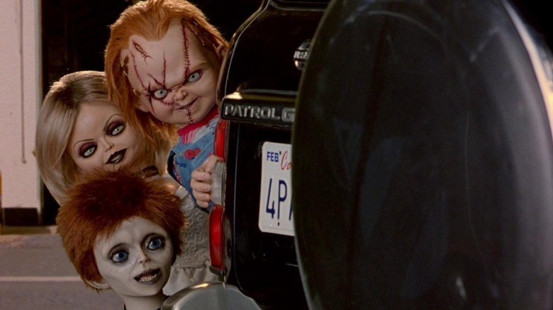 Chucky, Glen, and Tiffany peeking behind car