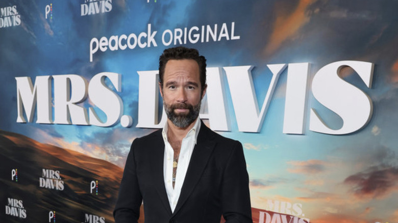 Chris Diamantopoulos posing at Mrs. Davis premiere