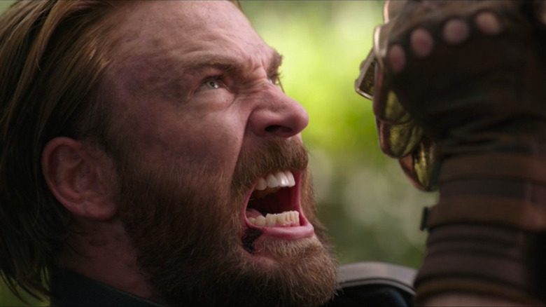 Captain America intensely fighting Thanos