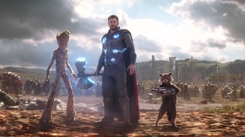 Thor, Groot, and Rocket standing together