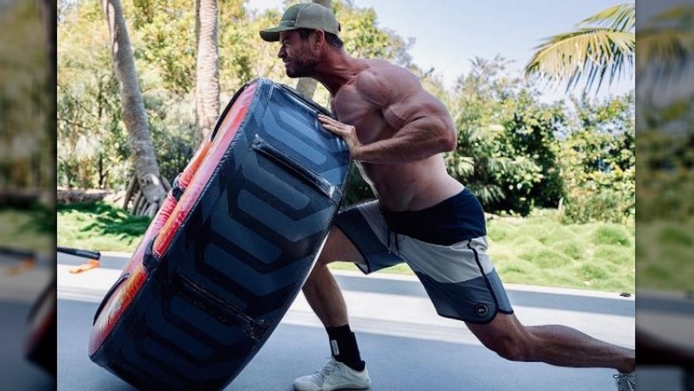 Chris Hemsworth working out with a doughnut