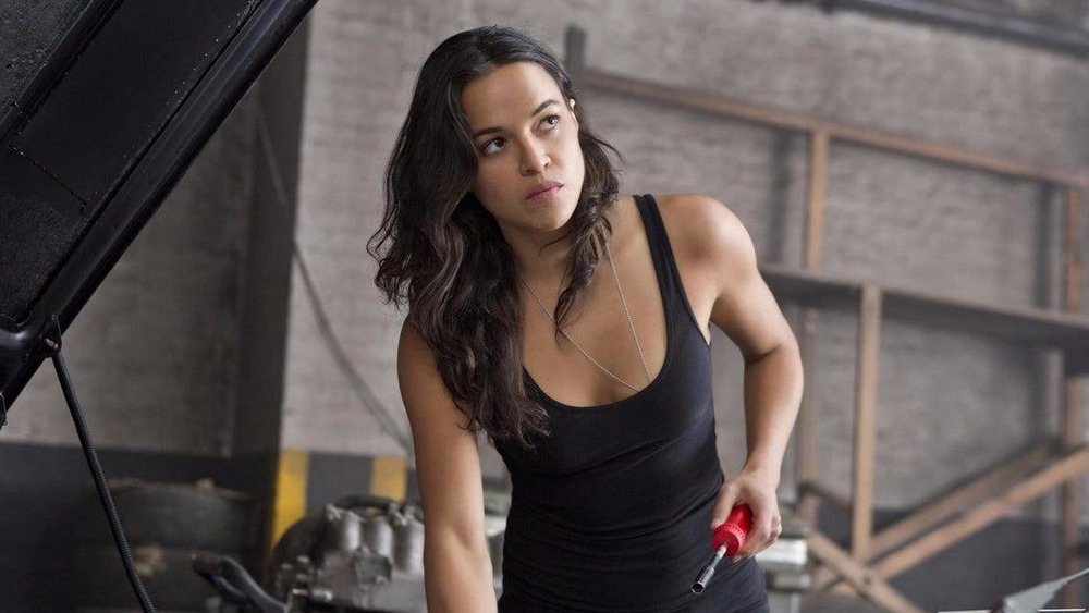 Fast & Furious Michelle Rodriguez works on an engine