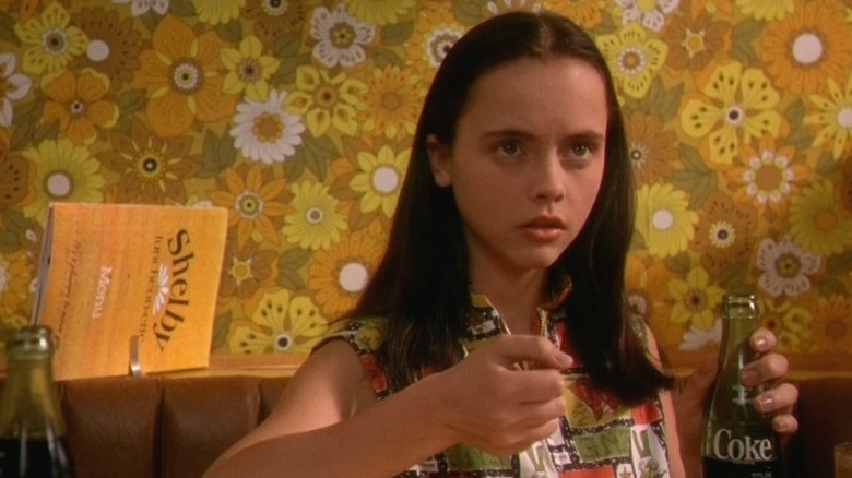 Christina Ricci holding coke bottle, looking away