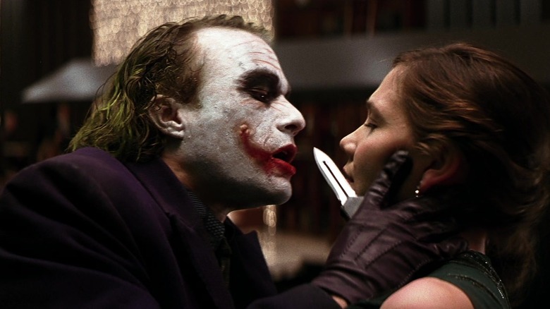 Joker threatening Rachel with knife