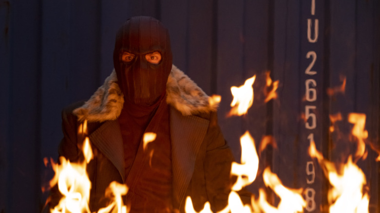 Masked Zemo behind fire