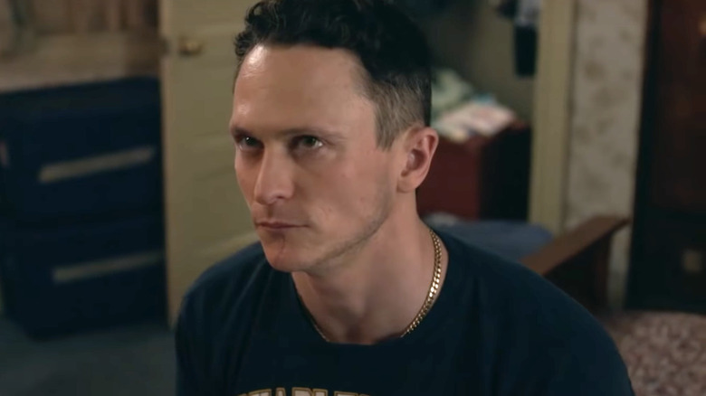 Jonathan Tucker sitting on a bed