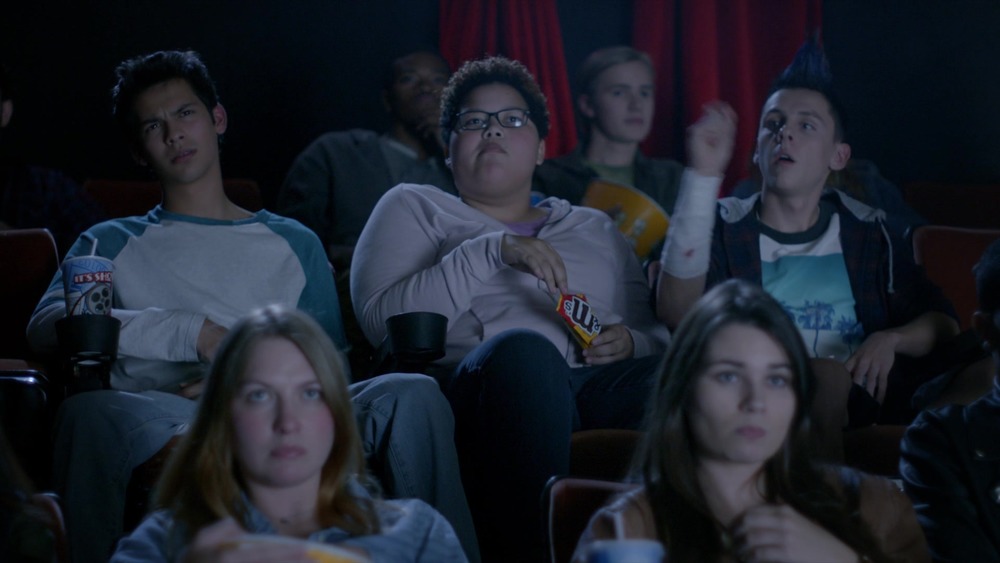 Miguel, Aisha, and Hawk in movie theater on Cobra Kai