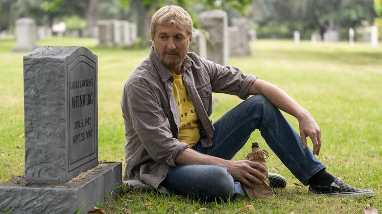 Johnny Lawrence drinking at Laura's grave in "Cobra Kai"