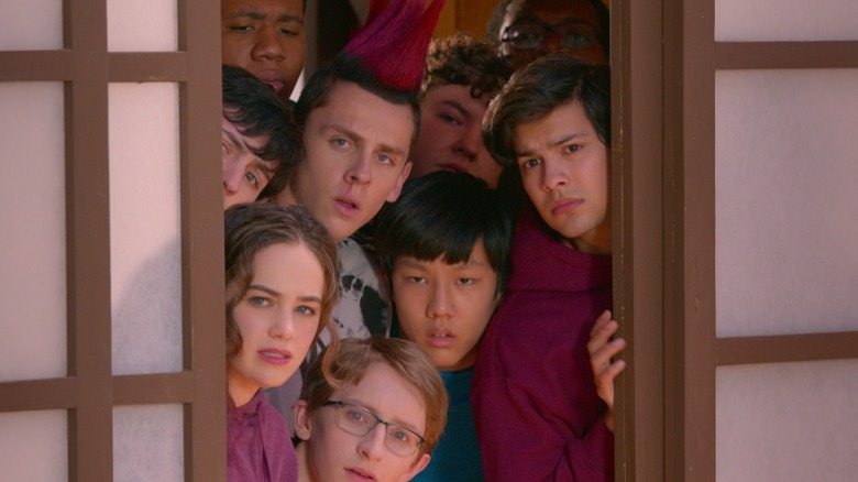 Members of Miyagi-Do all peering through a doorway looking concerned