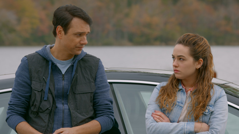 Ralph Macchio and Mary Mouser outside a car