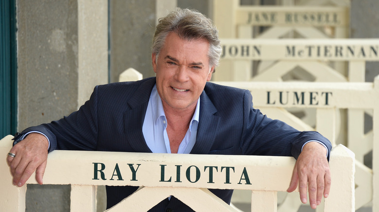 Ray Liotta smiling behind a Ray Liotta sign