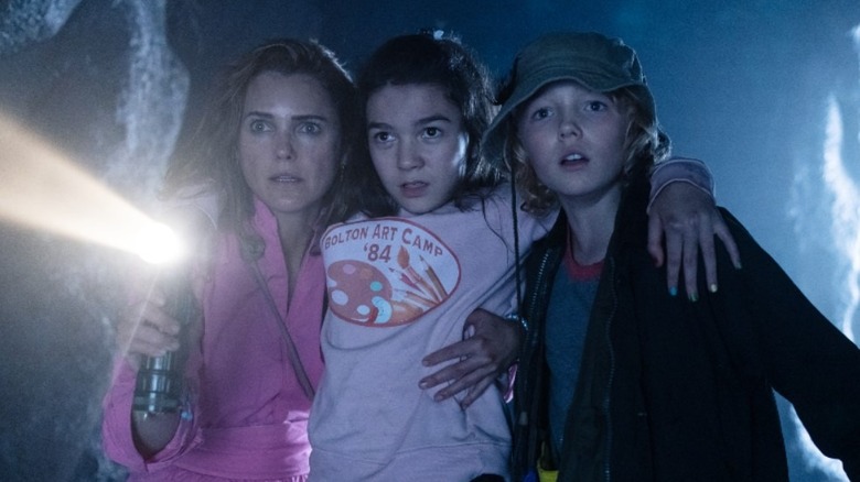 Keri Russell, Brooklynn Prince, and Christian Convery looking scared in dark in "Cocaine Bear"