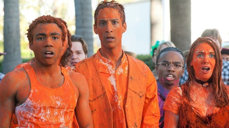 Troy, Abed and Annie covered in orange paint