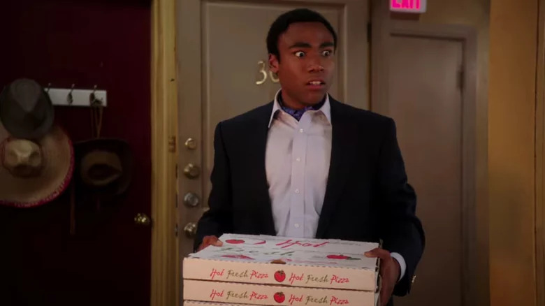 Confused Troy Barnes holding pizza