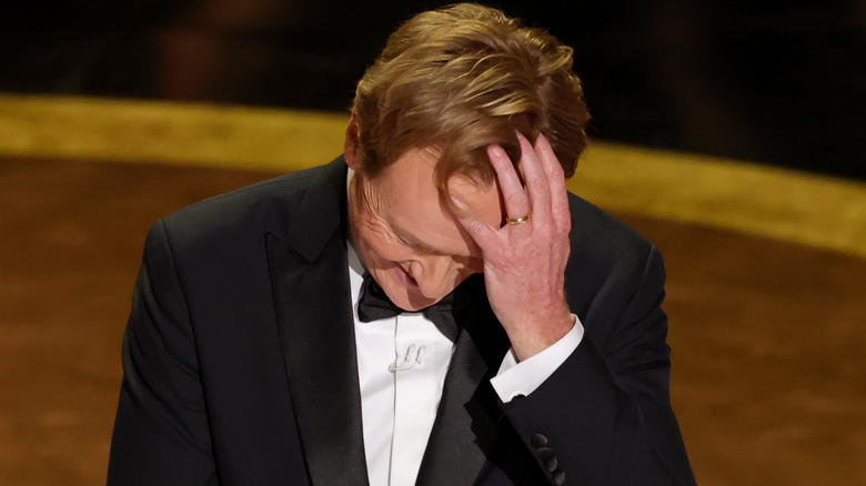 Conan with his head in his hands at the Oscars