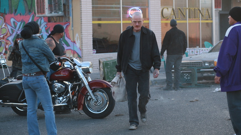 Walter White walks past bikers