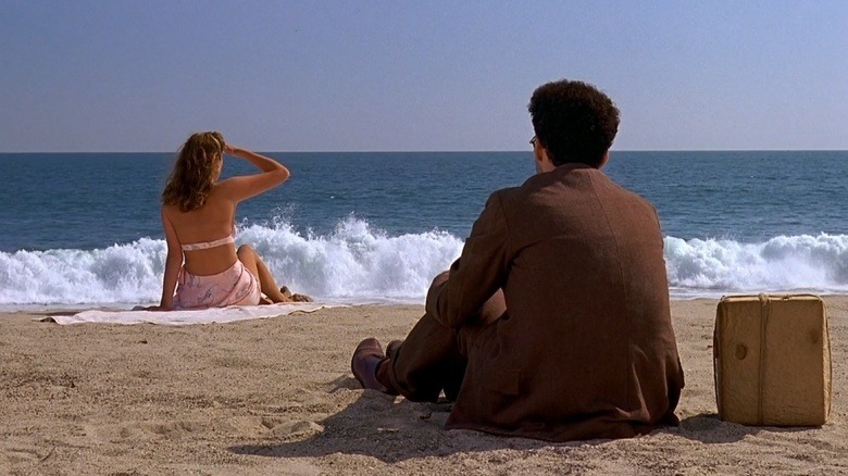 Barton Fink sits on beach