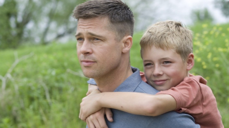 Mr. O'Brien and boy in field