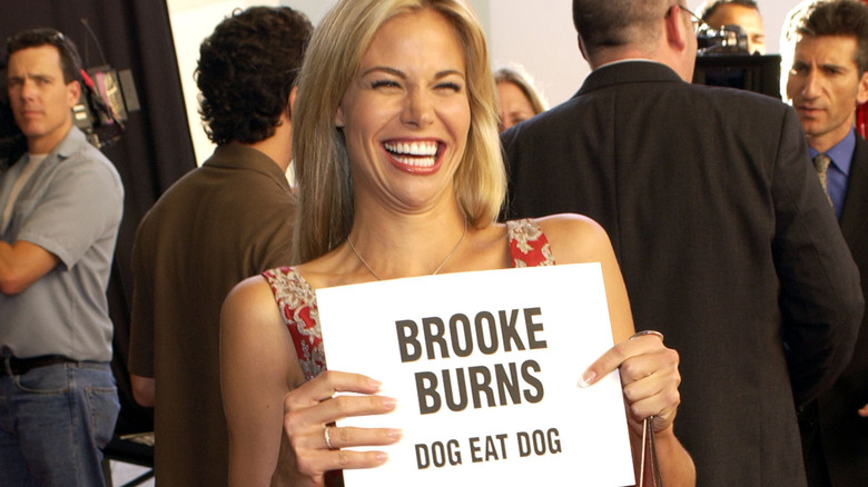 Brooke Burns holding a Dog Eat Dog sign