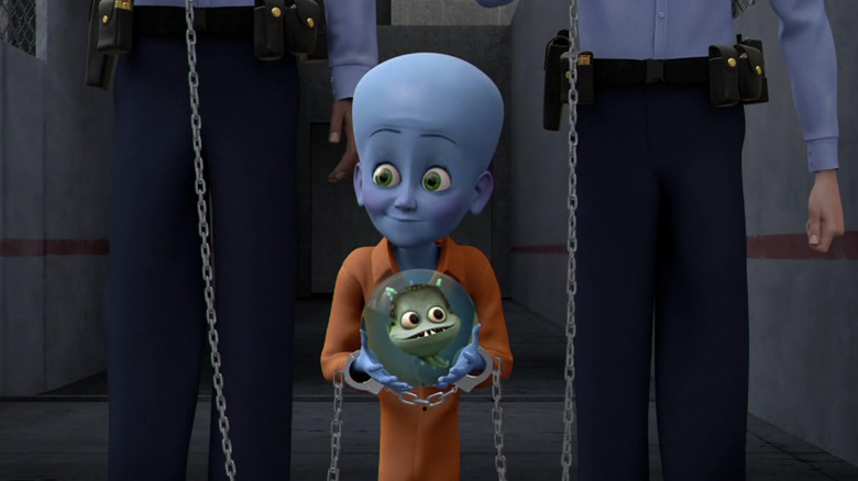 Chained up Megamind holds globe 