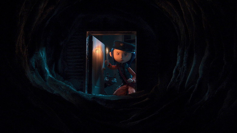 Coraline looking down dark tunnel