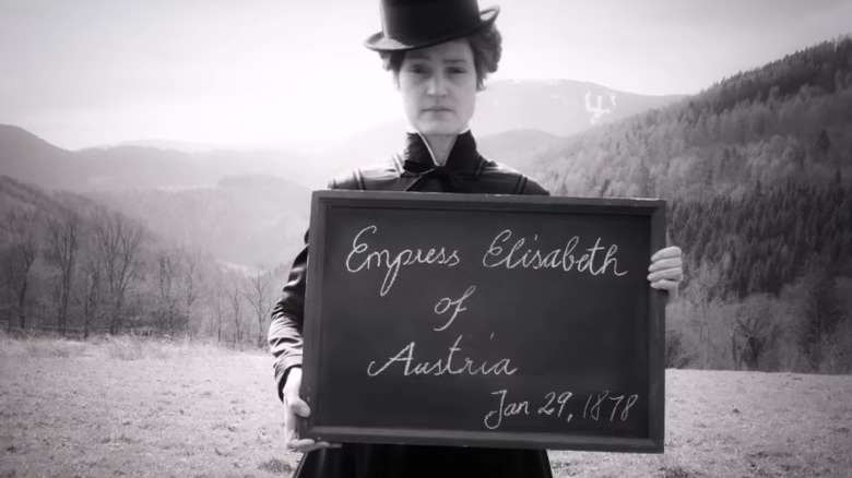 Empress Elisabeth holding a blackboard in Corsage