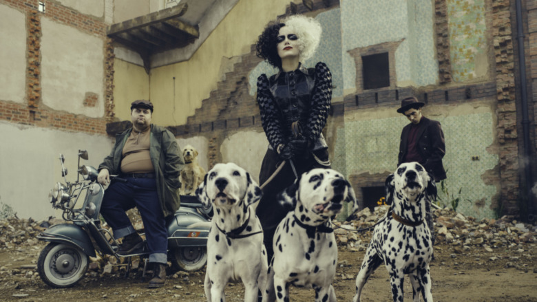 Paul Walter Hauser, Emma Stone and Joel Fry in Cruella