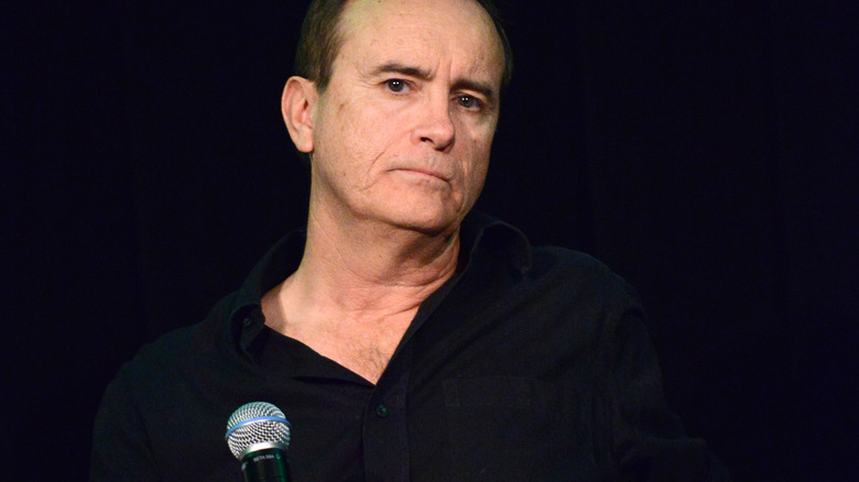 Jeffrey Combs onstage with microphone