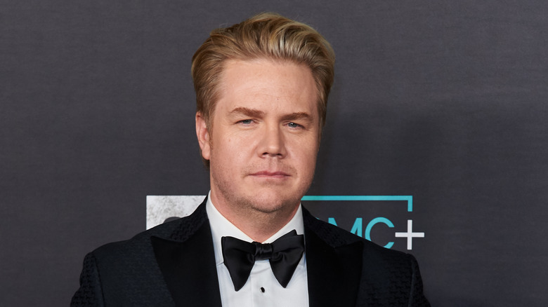 Josh McDermitt posing in suit