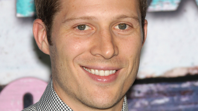 Zach Gilford smiling into camera