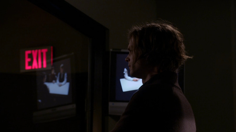 Spencer Reid observing through glass