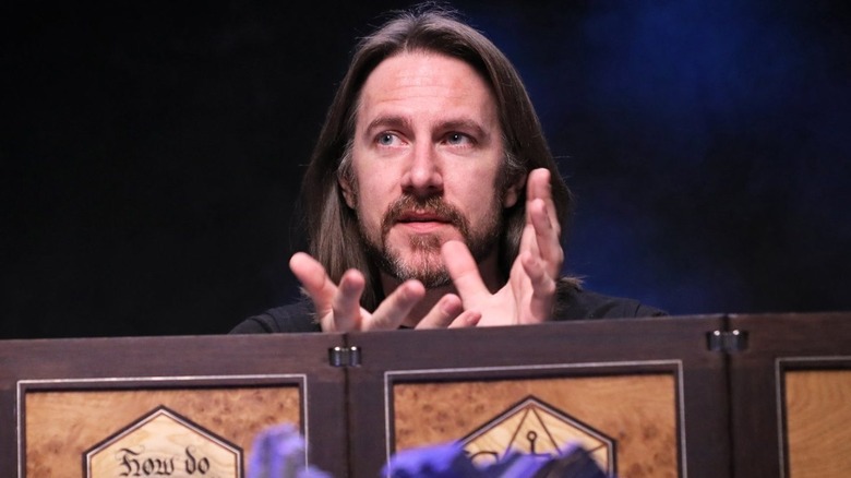 Matthew Mercer sits behind a DM screen