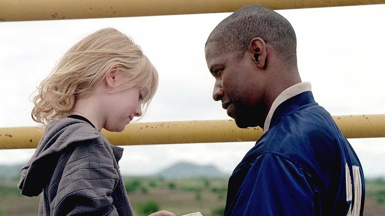 Creasy and Pita share a moment in "Man on Fire" (2004)